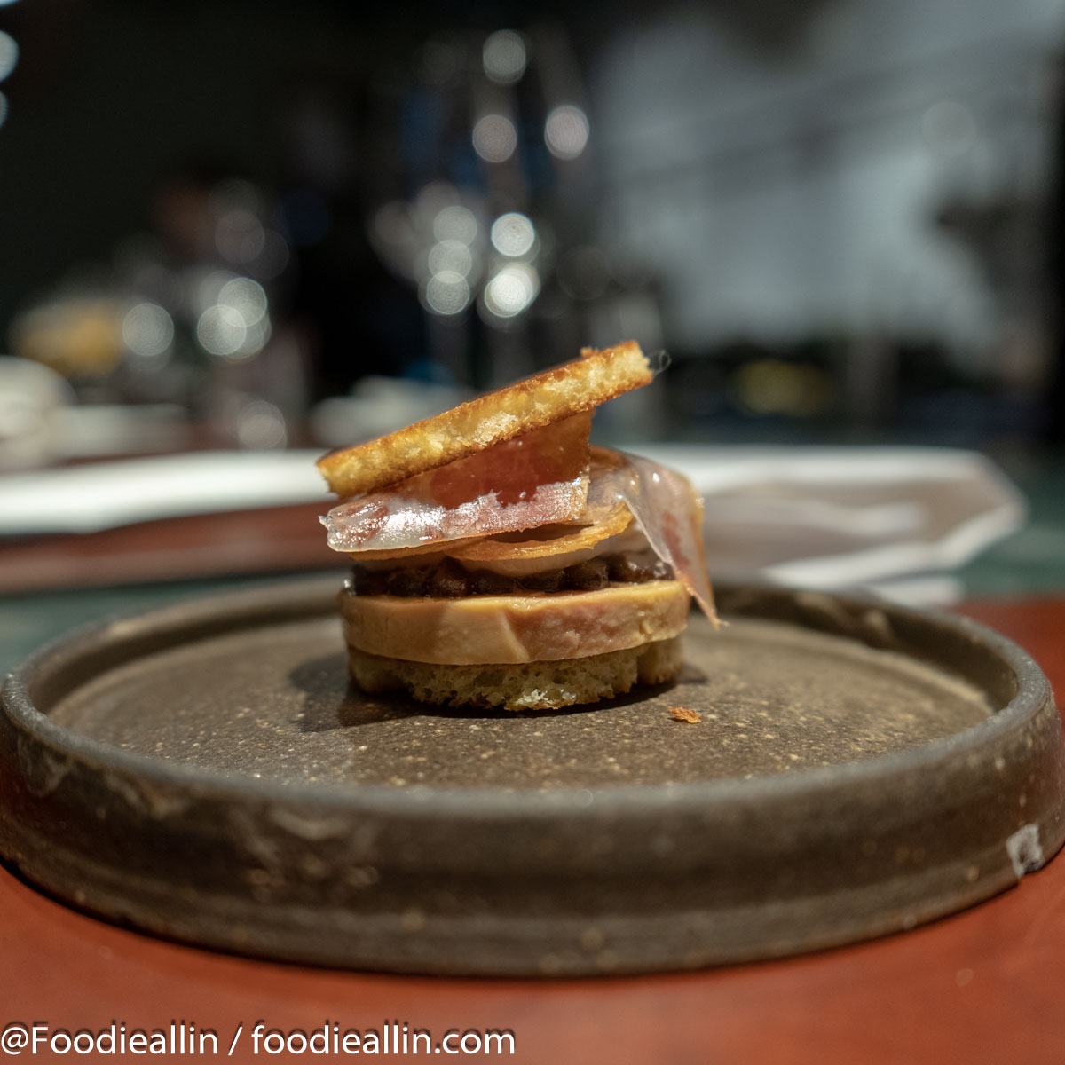 Foie Gras ”au torchon” with toasted brioche, crispy onion, house made charkuteries and date and black garlic puré.