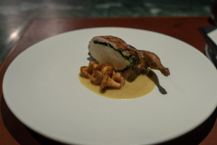 Roasted quail stuffed with quail mousse and spinach, served with girolles and curry.