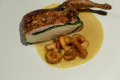 Roasted quail stuffed with quail mousse and spinach, served with girolles and curry.