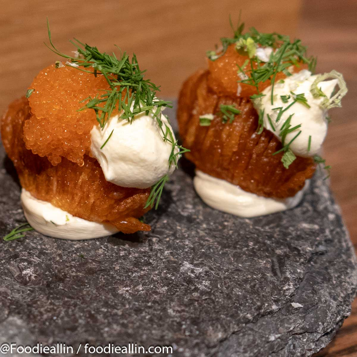 Hasselback potatoes, bleak roe, sour cream and spring onions