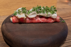 Thinly sliced raw beef with Jerusalem artichoke, gruyère cheese and hazelnuts